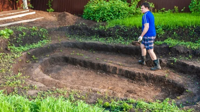 man digs garden pond