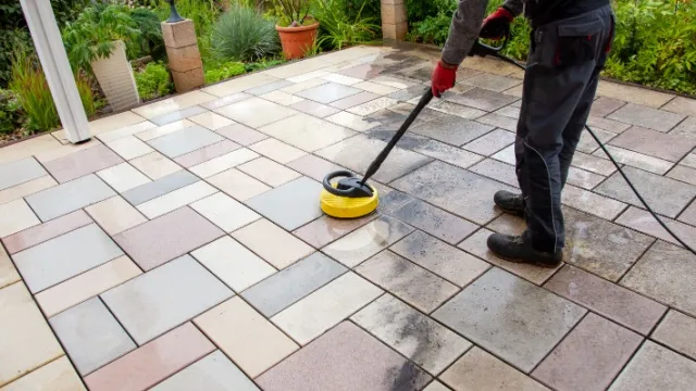 man cleans concrete terrace