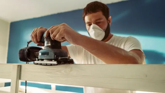 man working with sander