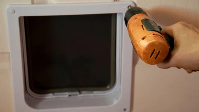 man screwing flap with drill
