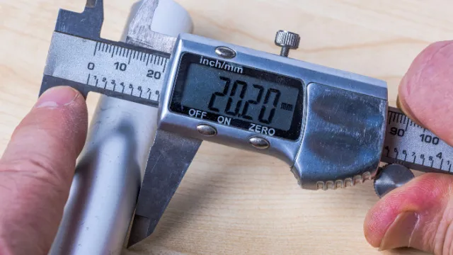 man measuring with a digital caliper