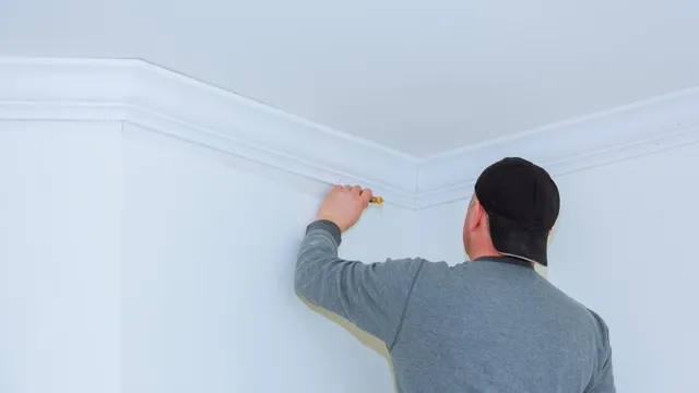 man placing cornice