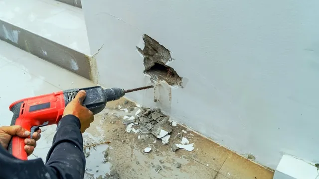 man drills into wall