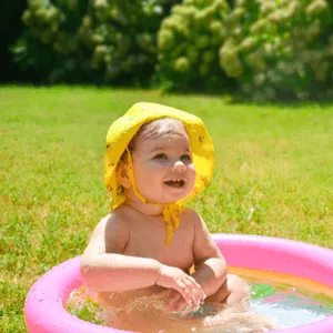 toddler in swimming pool on lawn