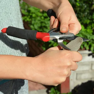 man sharpening shears with whetstone
